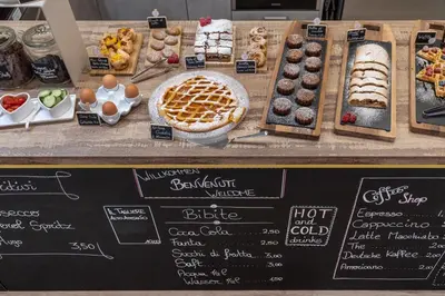 a display of pastries and desserts on a counter at Maison Valentina in Merano