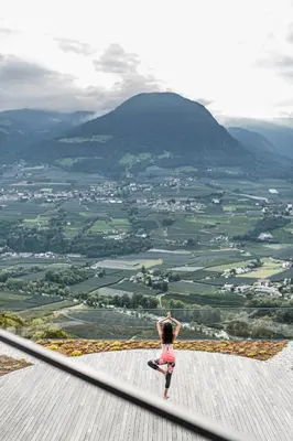 a person riding a skateboard on top of a mountain at Vinea - Suites in Tirolo