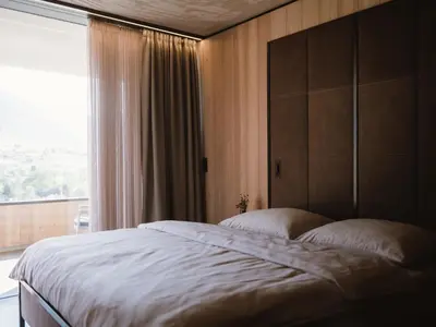 a bedroom with a large bed and a window at Lindenhof Pure Luxury & Spa DolceVita Resort in Naturno