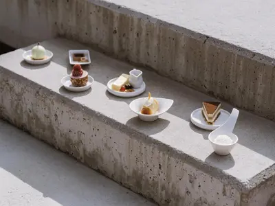 a group of desserts in bowls on a concrete ledge at Lindenhof Pure Luxury & Spa DolceVita Resort in Naturno