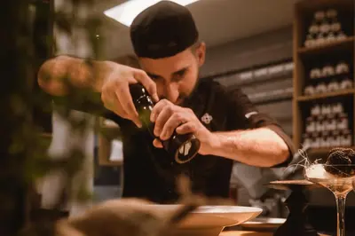 a man pouring a drink into a glass at Lindenhof Pure Luxury & Spa DolceVita Resort in Naturno