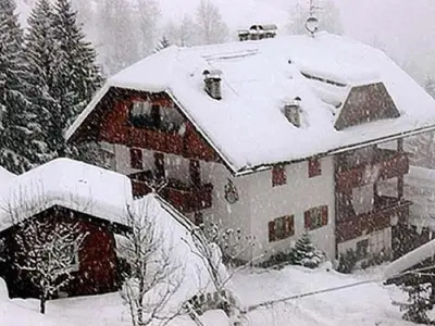 a house with snow on the roof of it at Flatscherhof in San Lorenzo di Sebato