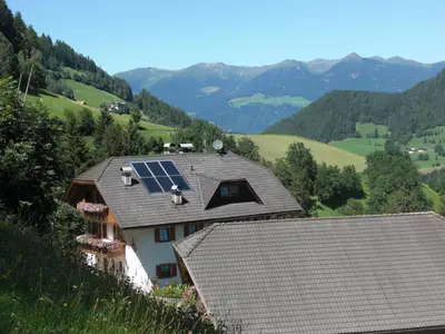 a house with solar panels on top of it at Flatscherhof in San Lorenzo di Sebato