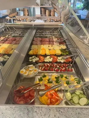 a buffet line with many different types of food at Hotel Weinberg in Appiano sulla Strada del Vino
