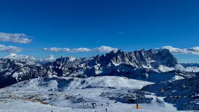 a view of a snowy mountain with skiers on a ski slope at IL COVO DELLO SCIATORE in Falcade
