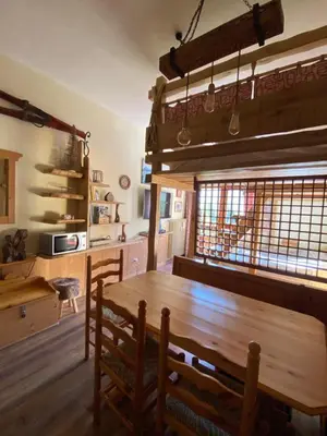 a dining room with a wooden table and chairs at IL COVO DELLO SCIATORE in Falcade