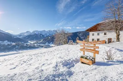 a sign on top of a snow covered mountain at Agriturismo MARER Urlaub auf dem Bauernhof in Villabassa