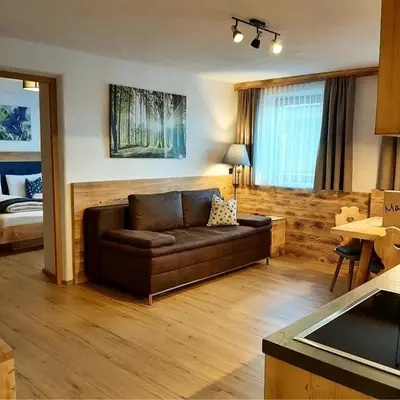 a living room with a couch and a bed at Agriturismo MARER Urlaub auf dem Bauernhof in Villabassa