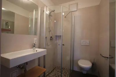 a bathroom with a shower and a sink and a toilet at Garni & Residence Sonngart in Lagundo
