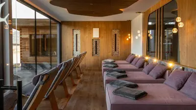 a row of tables in a room with chairs at Hotel Sun in Naz-Sciaves