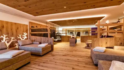 a large room with wooden floors and wooden walls at Hotel Sun in Naz-Sciaves