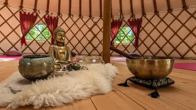 a gold statue sitting on a table in a yurt at Hotel Sun in Naz-Sciaves