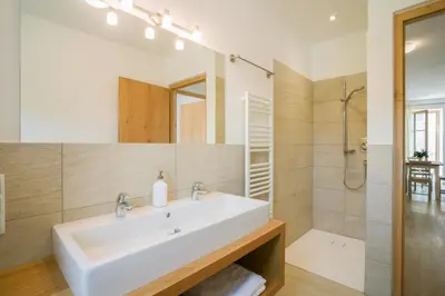 a bathroom with a white sink and a shower at Obstbauernhof Bundschuh - Dogs welcome in Appiano sulla Strada del Vino