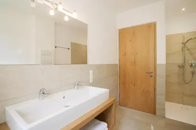a bathroom with a white sink and a mirror at Obstbauernhof Bundschuh - Dogs welcome in Appiano sulla Strada del Vino