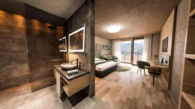 a hotel room with a bed and a bathroom at Hotel Klostersepp in Chiusa