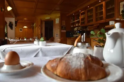a table with a plate of bread on a table at Garni Haus Tyrol in Corvara in Badia
