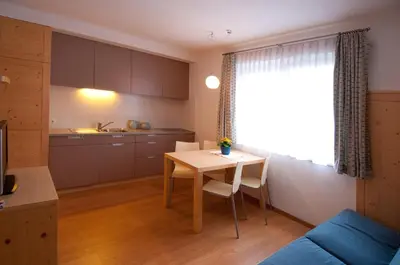 a kitchen and a table in a room at Gasthof Traube in San Lorenzo di Sebato