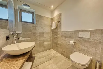a bathroom with a sink and a toilet at Hotel Klarnerhof in Schenna