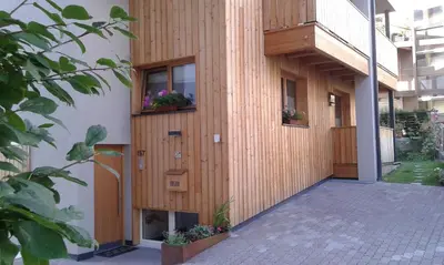 a building with two windows with flowers on it at Apartments Annemarie in Ortisei