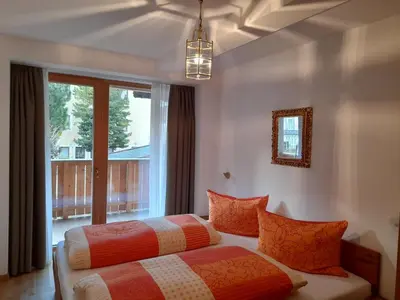 two beds in a room with a window at Apartments Annemarie in Ortisei
