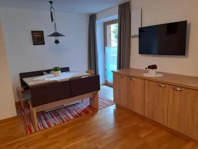 a living room with a flat screen tv on the wall at Apartments Annemarie in Ortisei