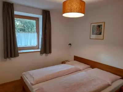 two beds in a bedroom with a window at Apartments Annemarie in Ortisei