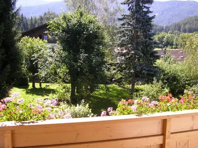 a garden with flowers and trees and a fence at Burgblick in San Lorenzo di Sebato