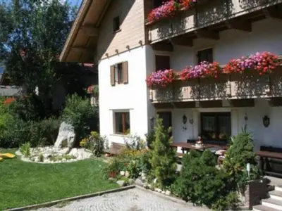 a large white building with flowers on the balconies at Burgblick in San Lorenzo di Sebato