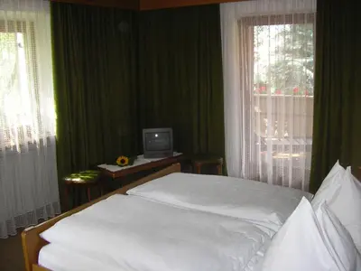 a bedroom with a bed and a computer on a desk at Burgblick in San Lorenzo di Sebato