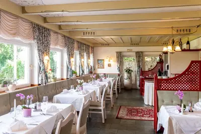 a row of tables in a restaurant at Hotel König Laurin in San Genesio Atesino