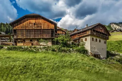 an old building on a hill with a green field at Lüch de Martin in La Valle