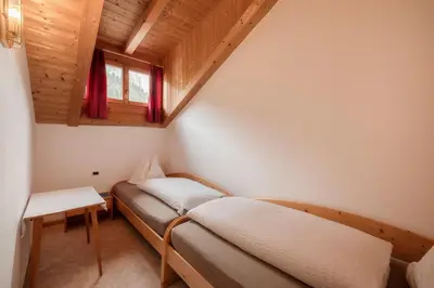 a kitchen with a table with a bowl of fruit on it at Luech da Plazola in Selva di Val Gardena
