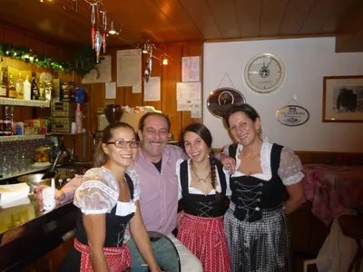 a group of people posing for a picture at a bar at Hotel Gran Pre in San Vigilio Di Marebbe