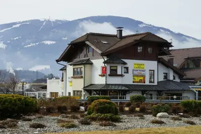 a large building with a mountain in the background at Pizzeria Restaurant Wieser in Rasùn di Sotto