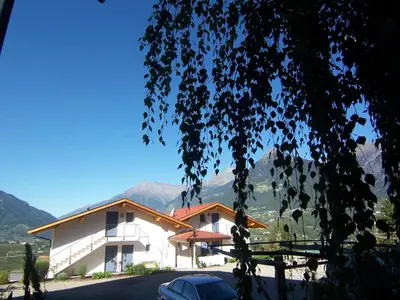 a building with a car parked in front of it at Der Blaue Reiter in Schenna