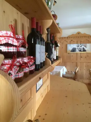 a bunch of wine bottles on a shelf in a room at Hotel Garnì Salvanel in Cavalese
