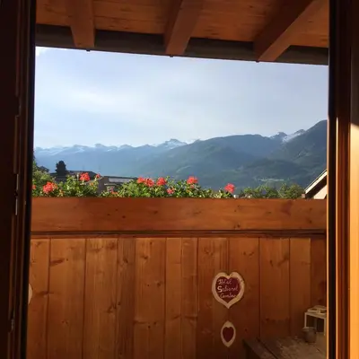 a window with a view of the mountains at Hotel Garnì Salvanel in Cavalese