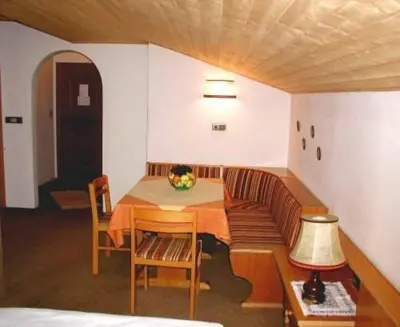 a living room with a couch and a table at Apparthotel Taufenbrunn in Parcines