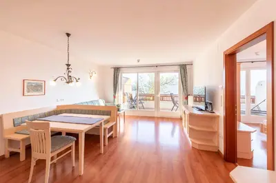 a kitchen and dining room with a table and chairs at Appartement Tschivon in Schenna