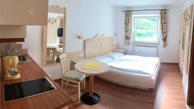 a small room with a bed and a table in it at Appartement Tschivon in Schenna