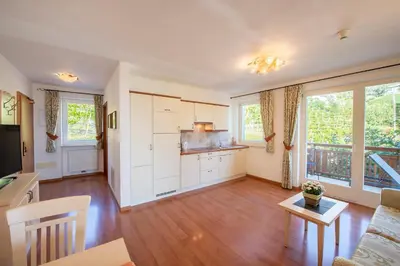 a kitchen and living room with a couch and a table at Appartement Tschivon in Schenna