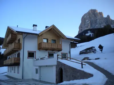 a house in the mountains with snow on the ground at Prensanueva in Santa Cristina in Val Gardena