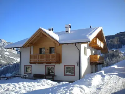 a house with a balcony in the snow at Prensanueva in Santa Cristina in Val Gardena