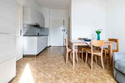 a kitchen and dining room with a table and chairs at Apartment Villa Schmid in Bolzano
