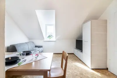 a kitchen and dining room with a table and chairs at Apartment Villa Schmid in Bolzano