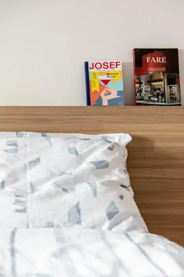 a headboard of a bed with a textbook and a book at Apartment Villa Schmid in Bolzano
