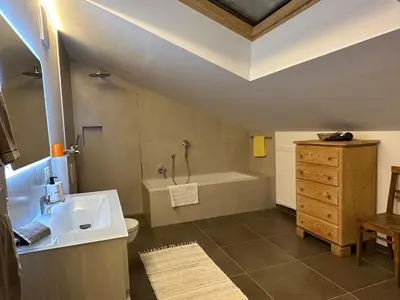 a bathroom with a sink and a bath tub at Pension Chalet Andy in Schenna