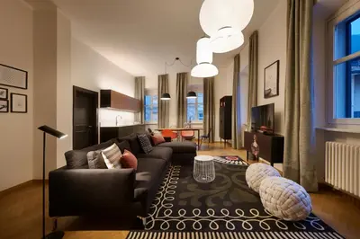 a living room with a couch and a table at Arte Apartments in Bolzano