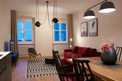 a living room with a red couch and a table at Arte Apartments in Bolzano
