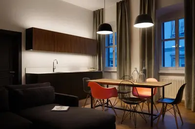 a kitchen and living room with a table and chairs at Arte Apartments in Bolzano